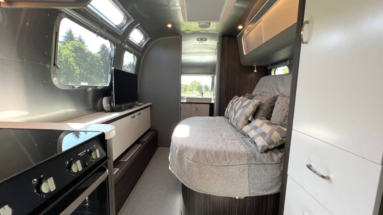 Innovations at Caravan Salon 2023: Airstream Germany presents luxury caravan with comfort bathroom and kitchen with oven 3 Airstream International 25IB bed retracted